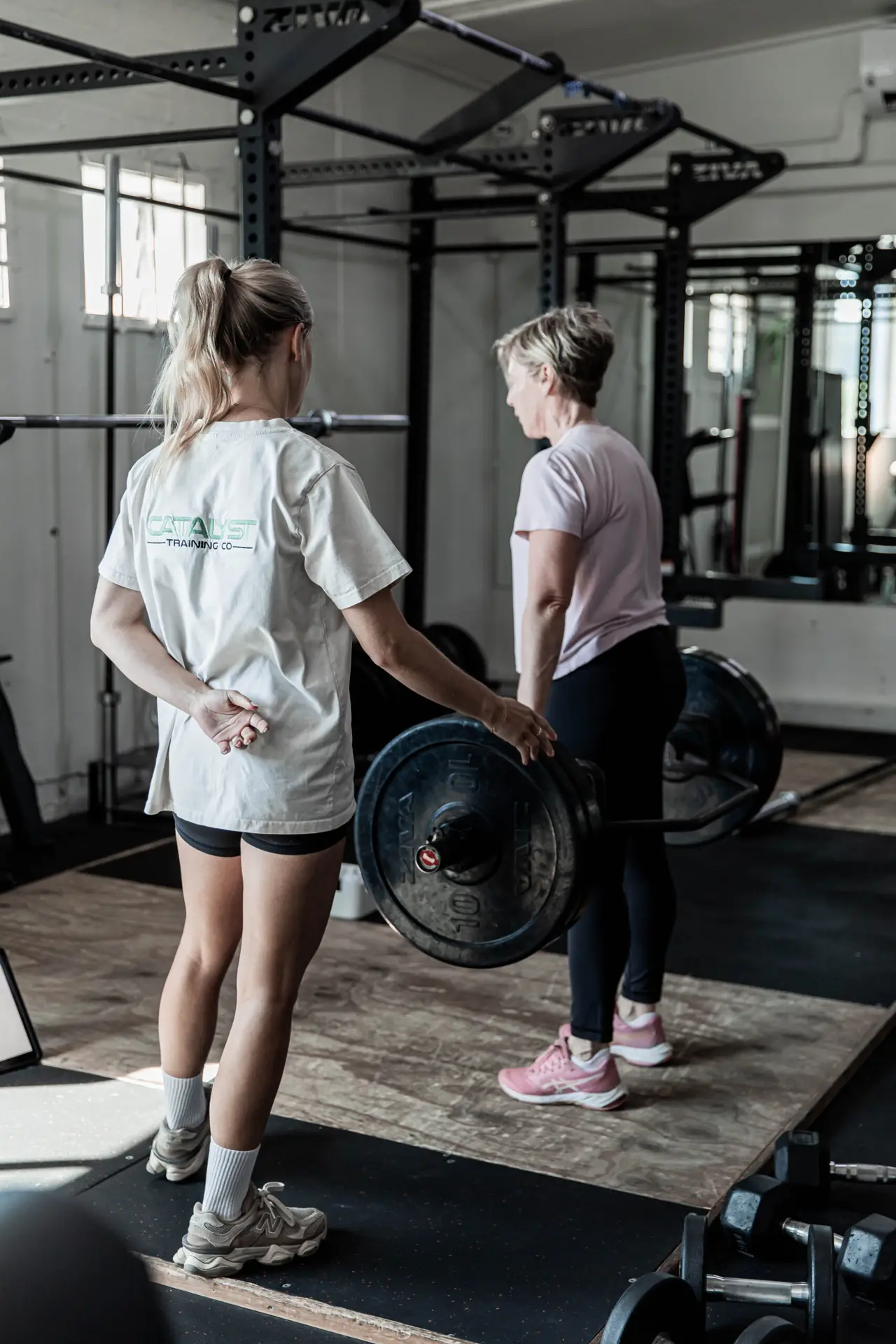 Female coach working with a member at the lifting platform at Catalyst Training Co Randwick