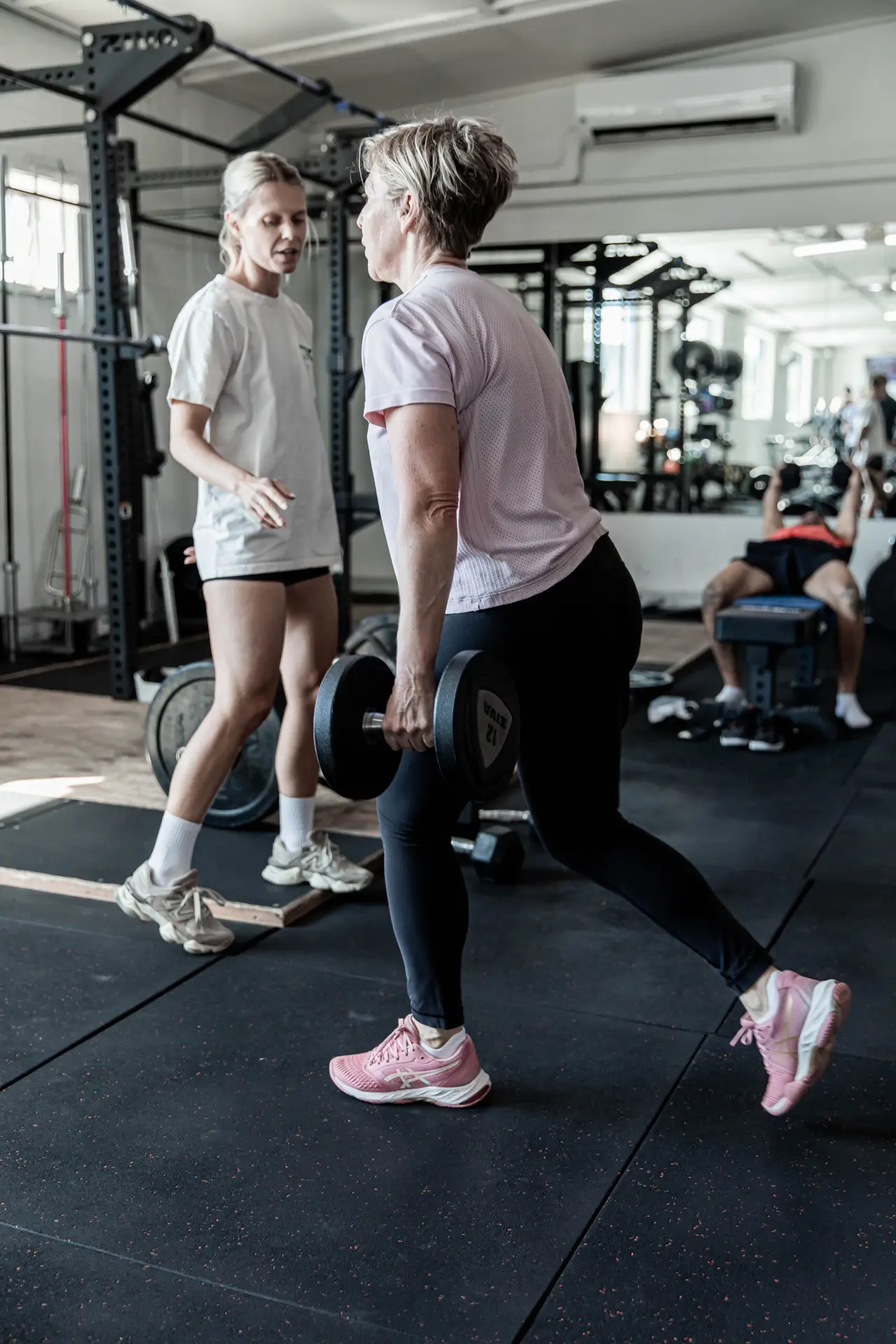 Coach guiding a member through loaded lunges at Catalyst Training Co Randwick