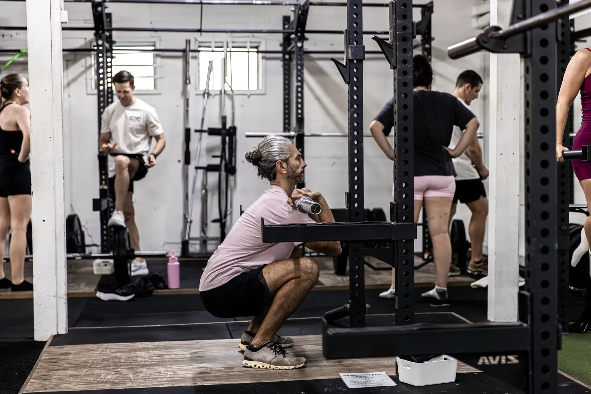 Member performing a barbell front squat on the gym floor at Catalyst Training Co Randwick