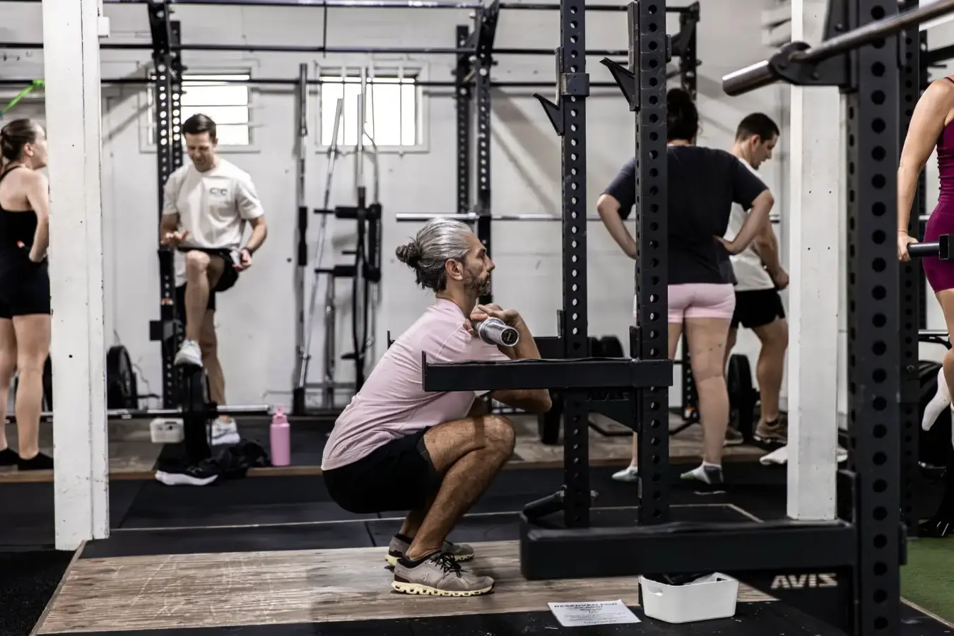 Member performing a barbell front squat on the gym floor at Catalyst Training Co Randwick