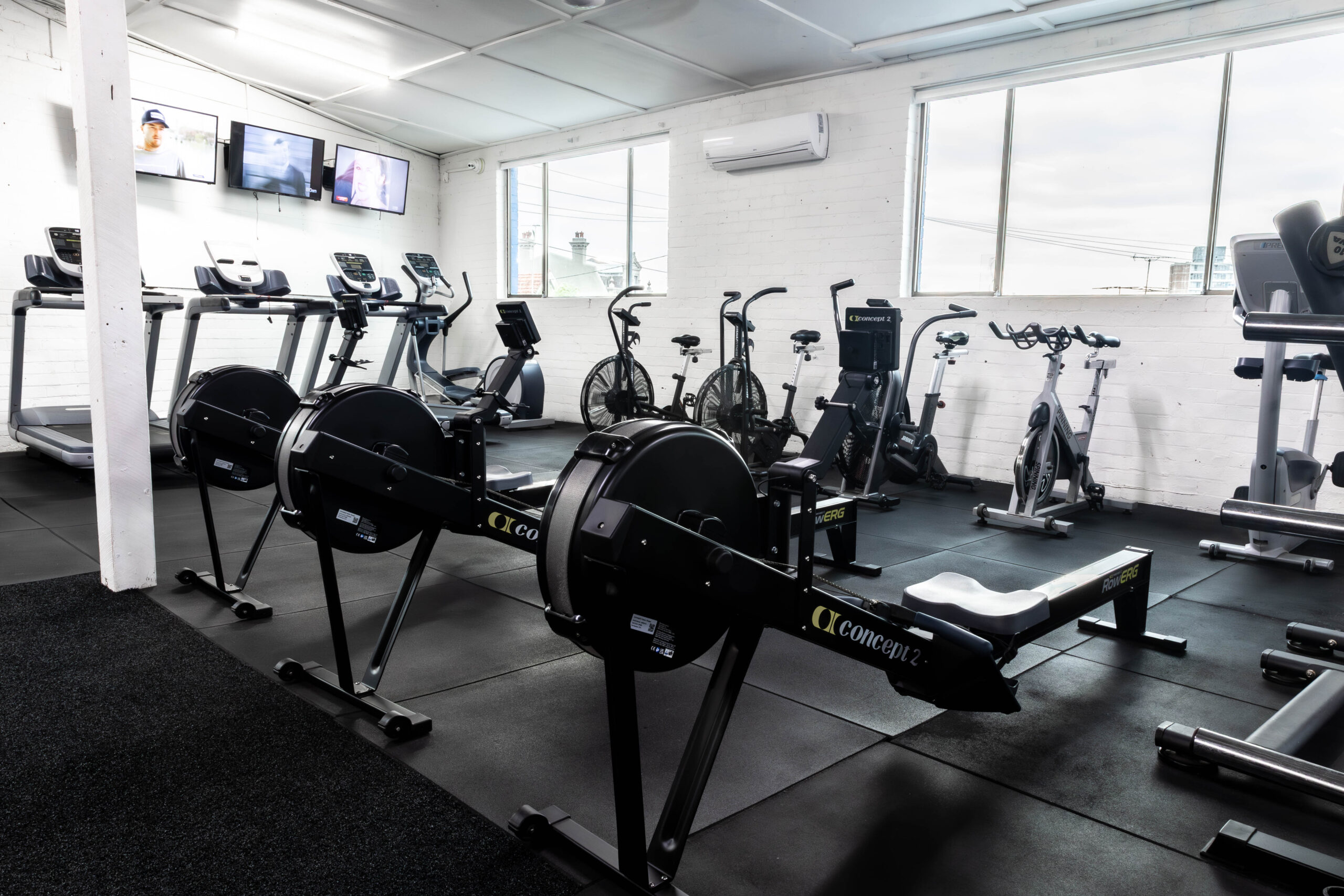 The conditioning zone at Catalyst Training Co Randwick with Concept2 rowers, air bikes and treadmills by the windows