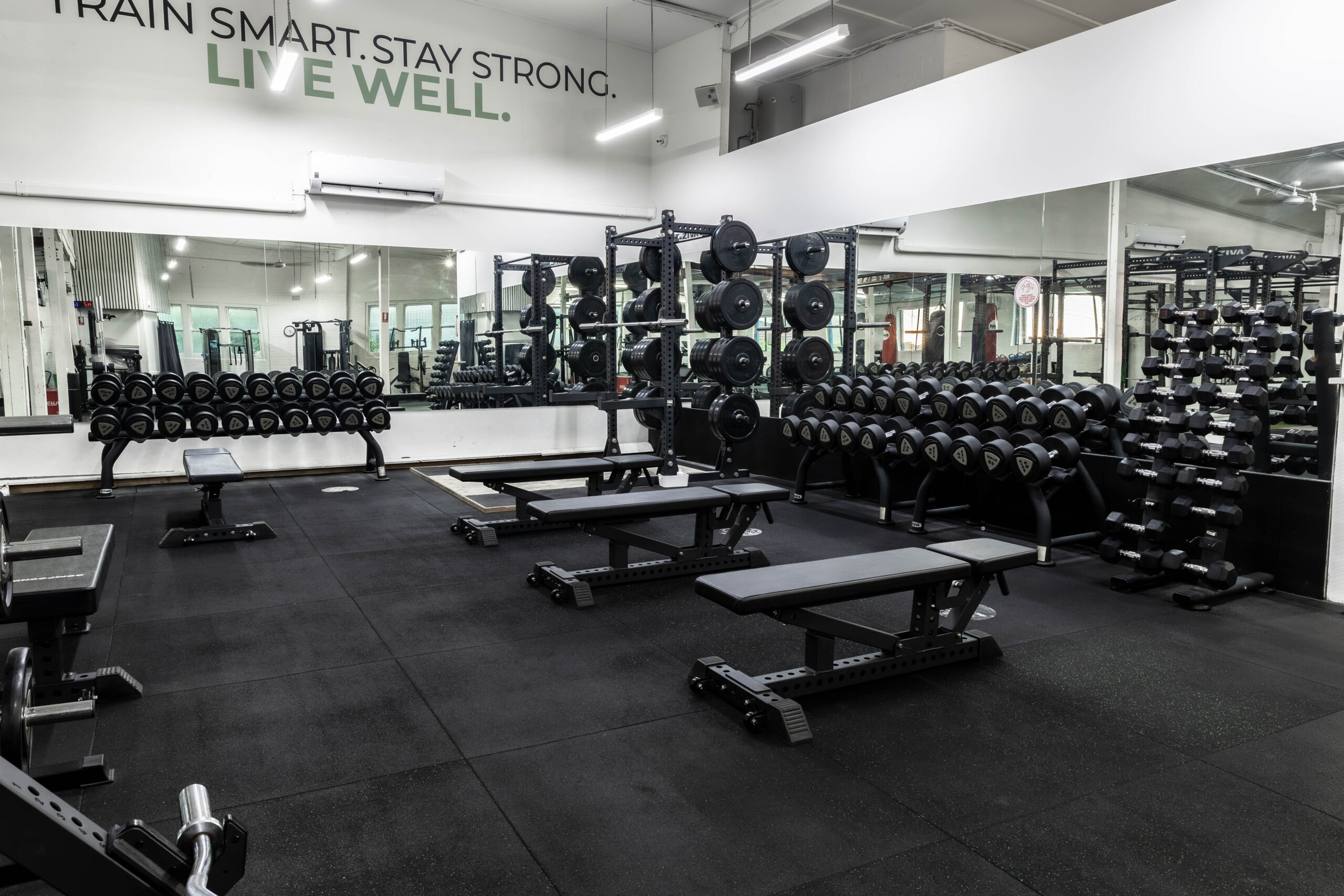 The strength floor at Catalyst Training Co Randwick with squat racks, bumper plates and full dumbbell racks