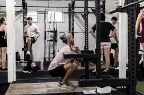 Member performing a barbell front squat on the gym floor at Catalyst Training Co Randwick