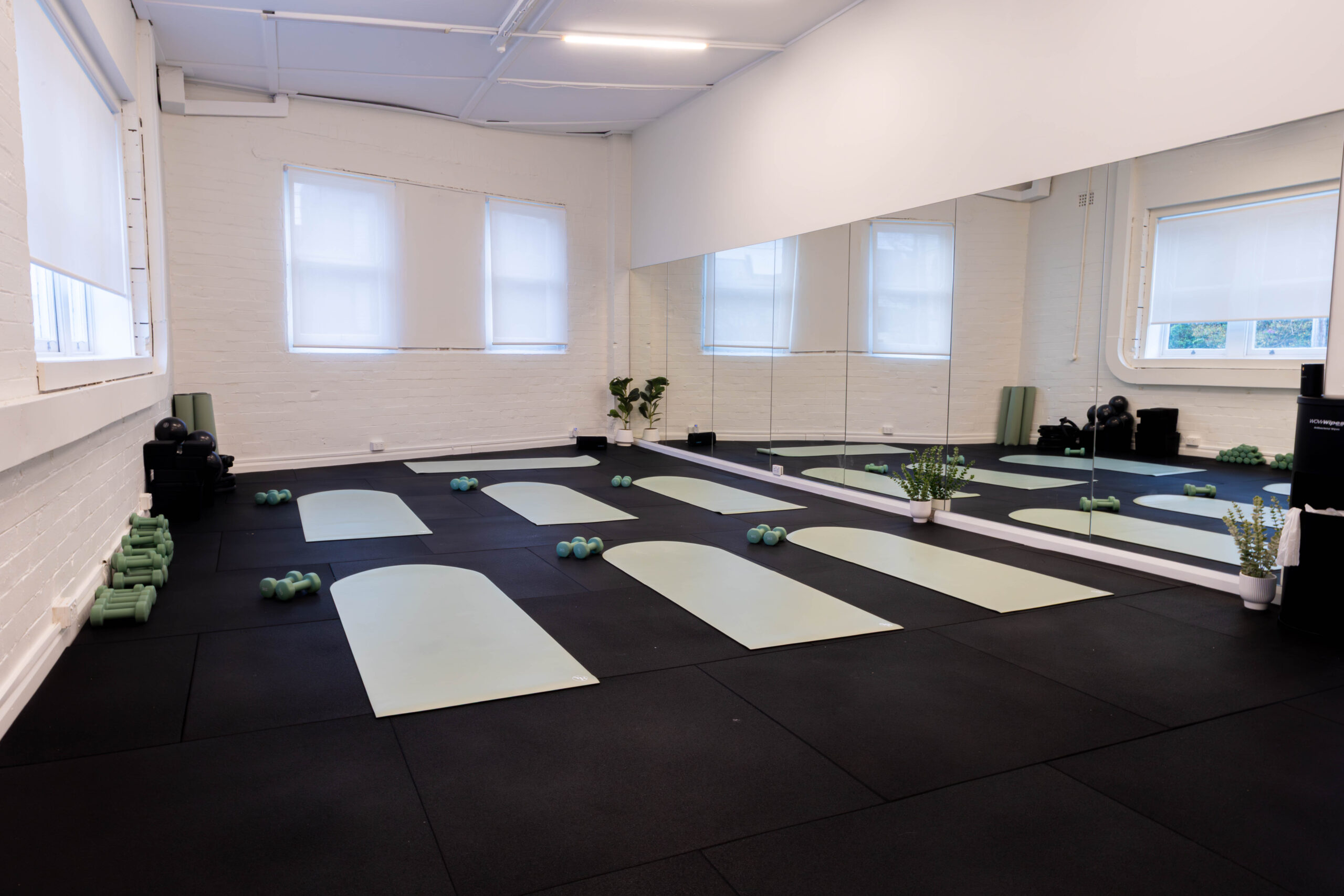 The same Catalyst Pilates studio in Randwick set up for a mat Pilates class with mats, light dumbbells and weighted balls