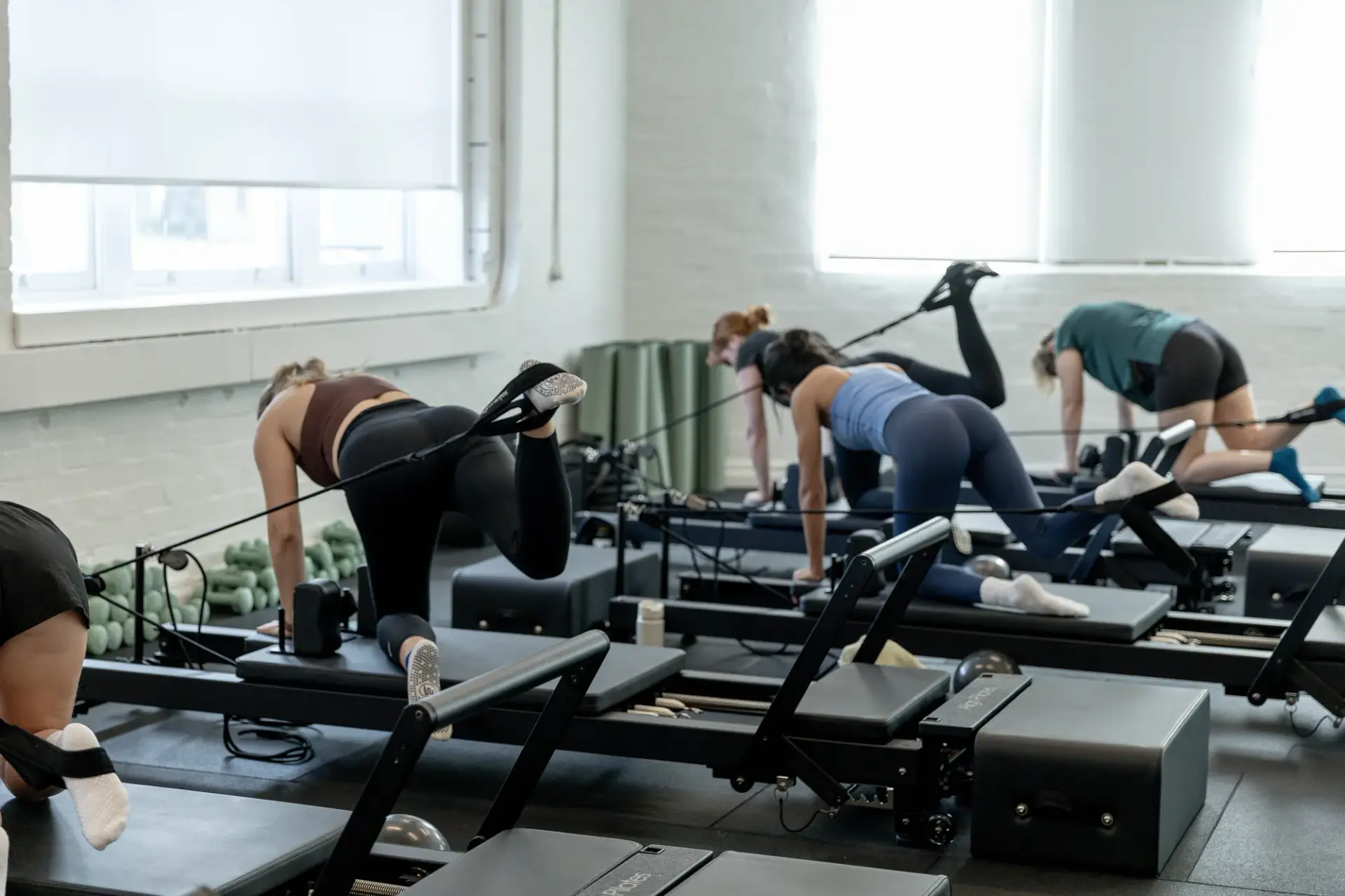 Reformer Pilates mobility and core work with leg straps